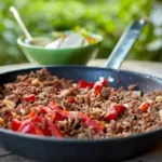 "A steaming bowl of traditional picadillo recipe with vibrant colors"