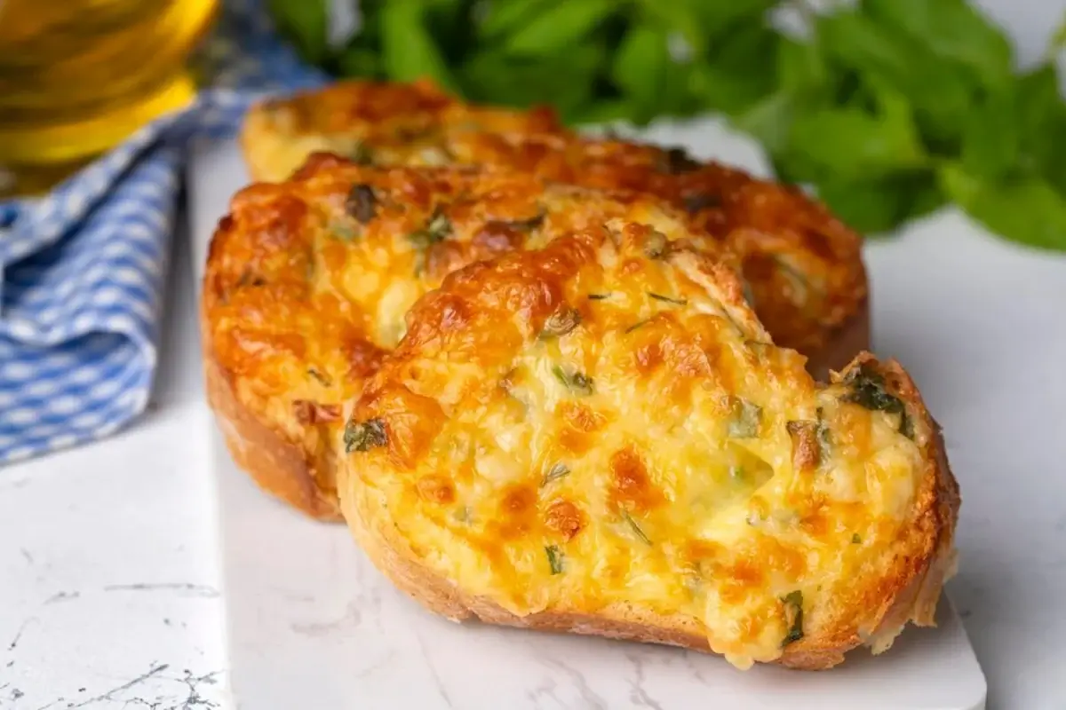 "Freshly baked cheesy garlic bread with melted cheese and herbs"