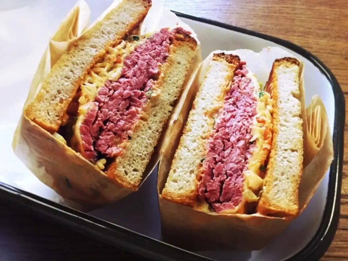 "A delicious Reuben sandwich showcasing melted Swiss cheese and sauerkraut"